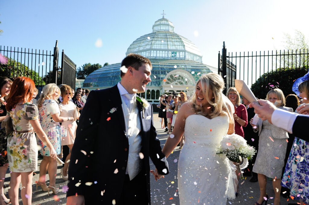 bride and groom in liverpool walking through confetti